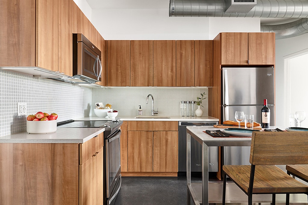 Kitchen Cabinets: Elegante (Slab) in Amati Walnut Thermofoil in Wilber School Apartment